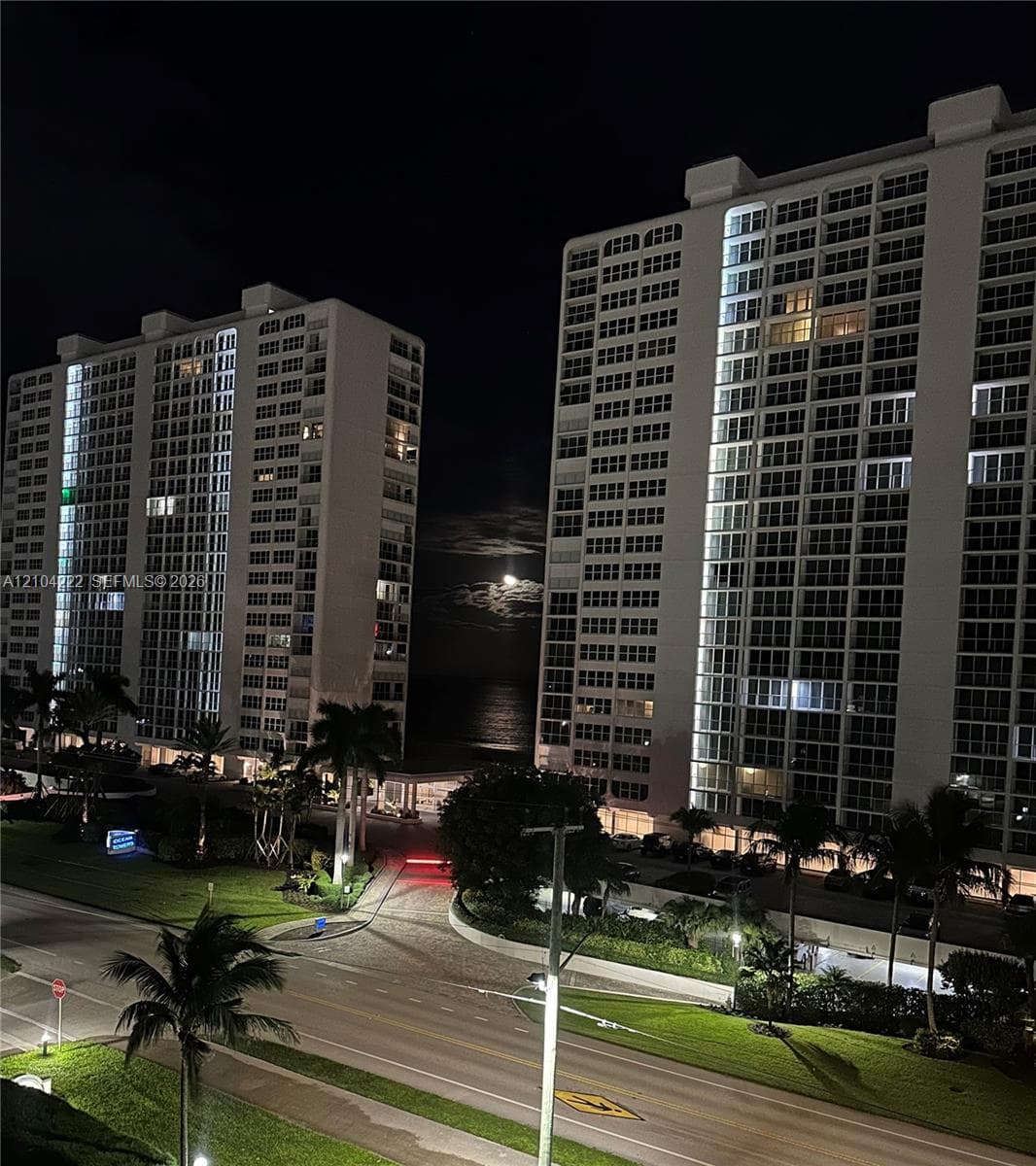 High-rise residential towers featuring expansive glass-paneled facades, private balconies, and manicured tropical landscaping