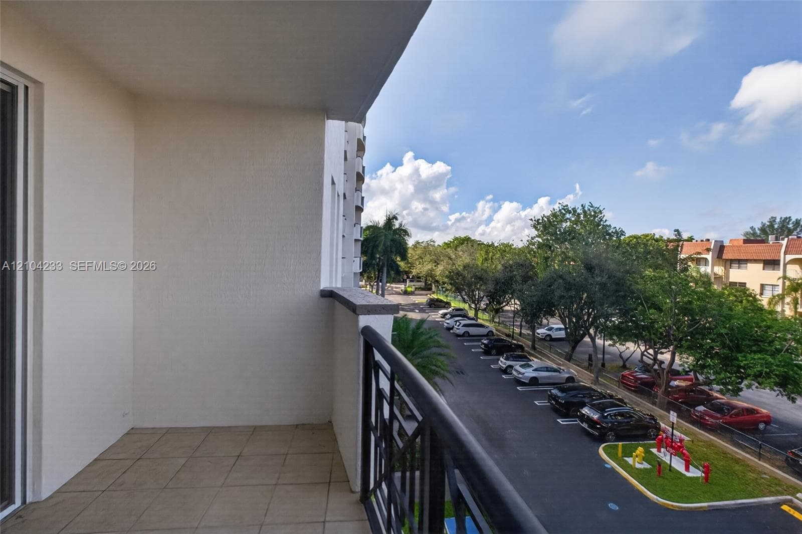 Private balcony featuring a tiled floor and a black metal railing