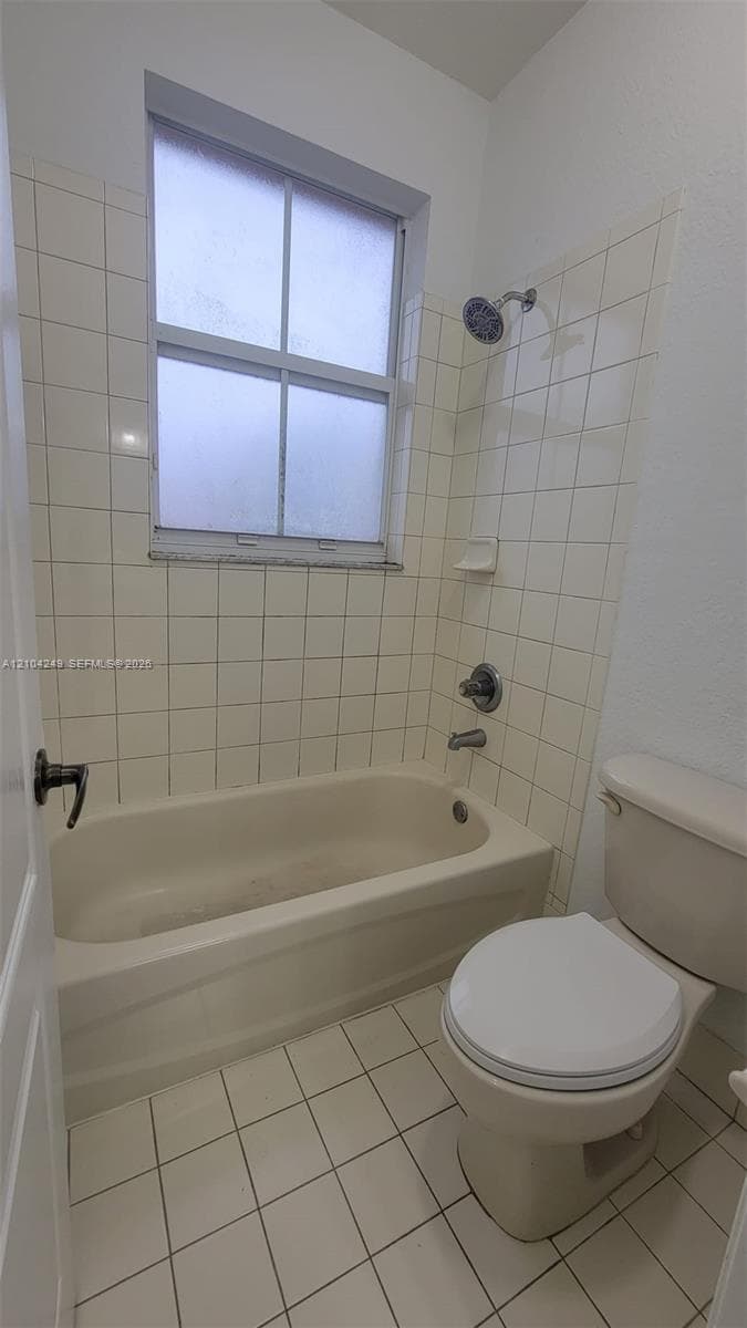 Downstairs bathroom featuring wood-finish flooring, white walls, and a window with horizontal blinds
