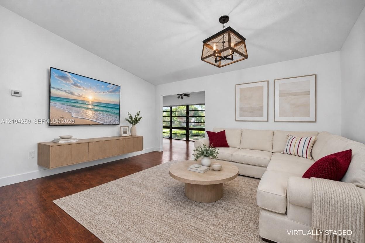 Wood-finish flooring, floating cabinetry, and a geometric pendant light fixture