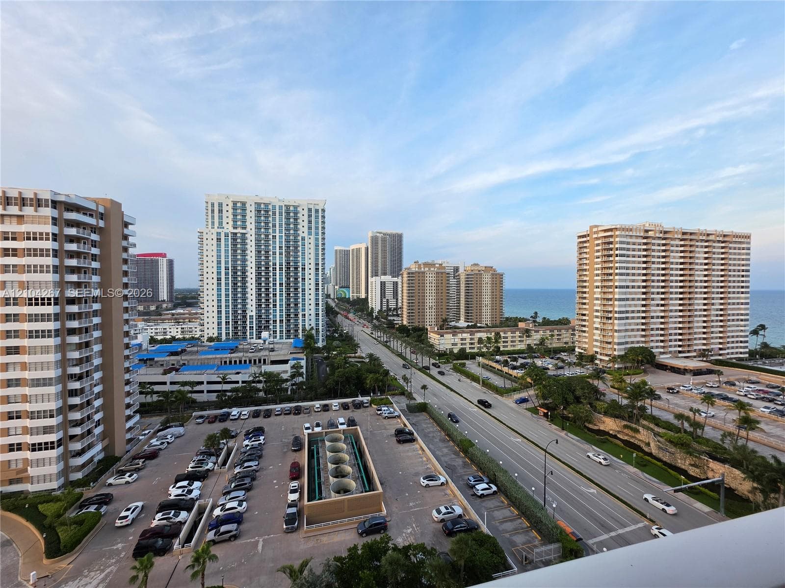Panoramic skyline and ocean horizon backdrop featuring high-rise architecture and coastal surroundings