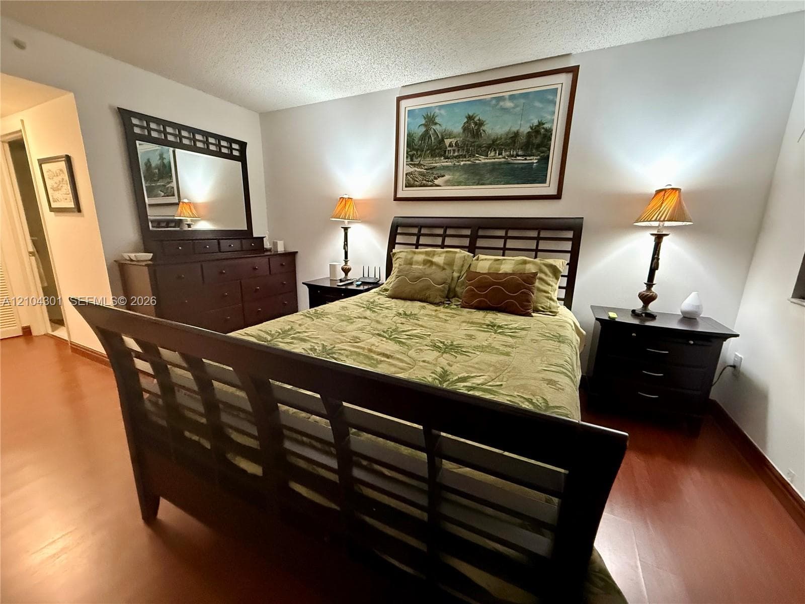 Bedroom featuring wood-finish flooring and neutral wall color