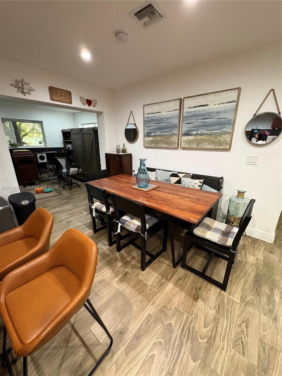 Interior space featuring wood-finish tile flooring and recessed ceiling lighting