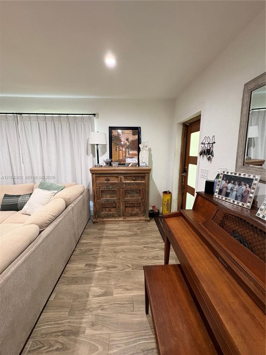 Wood-finish flooring and a door featuring frosted glass panels