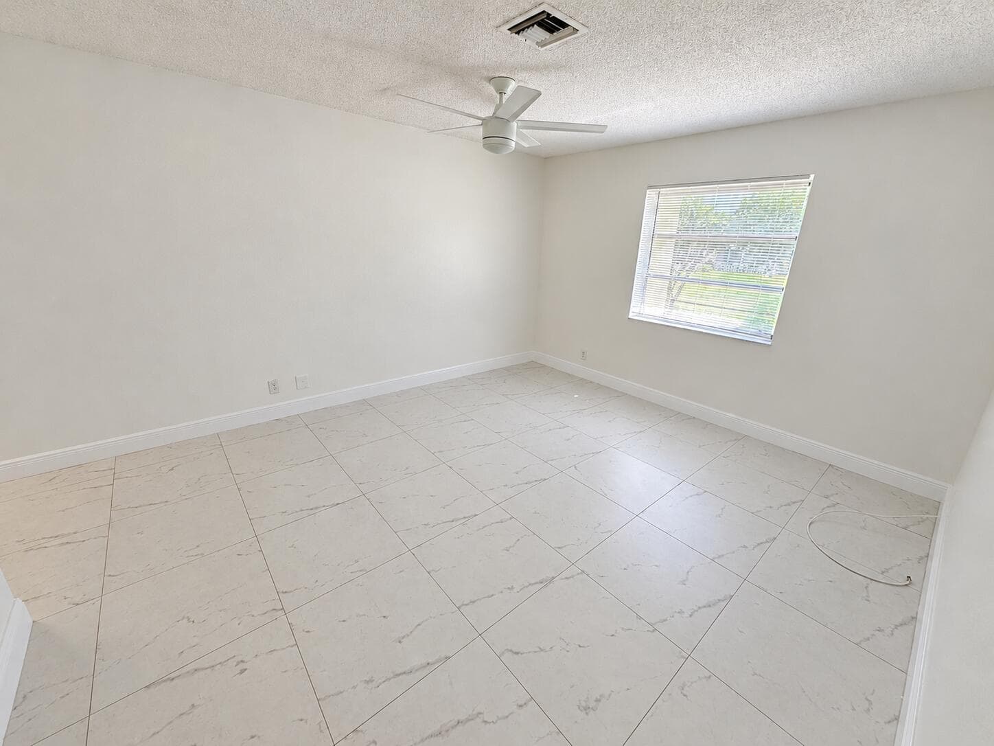 Bright Empty Room with Ceiling Fan