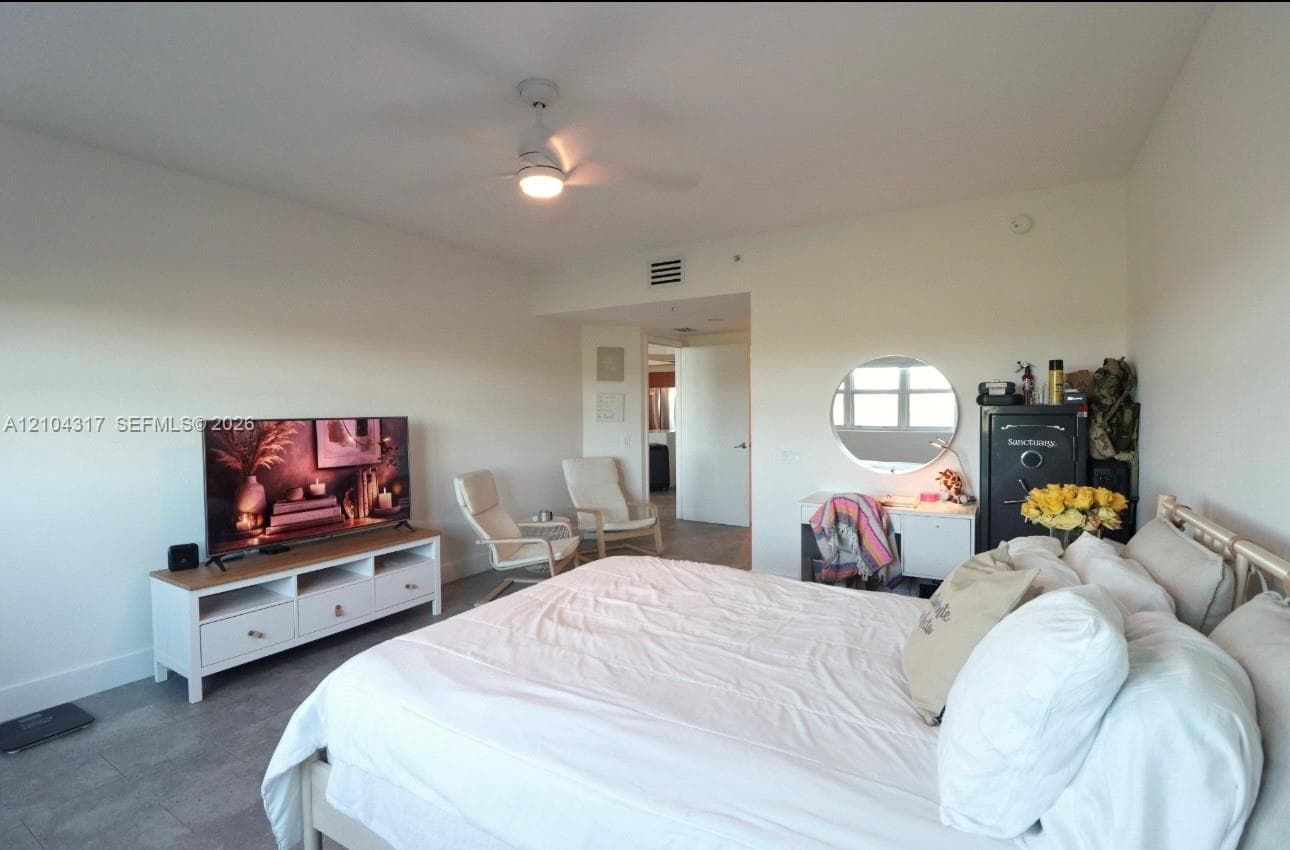 Neutral-toned interior featuring tiled flooring and a ceiling-mounted light fixture with a fan