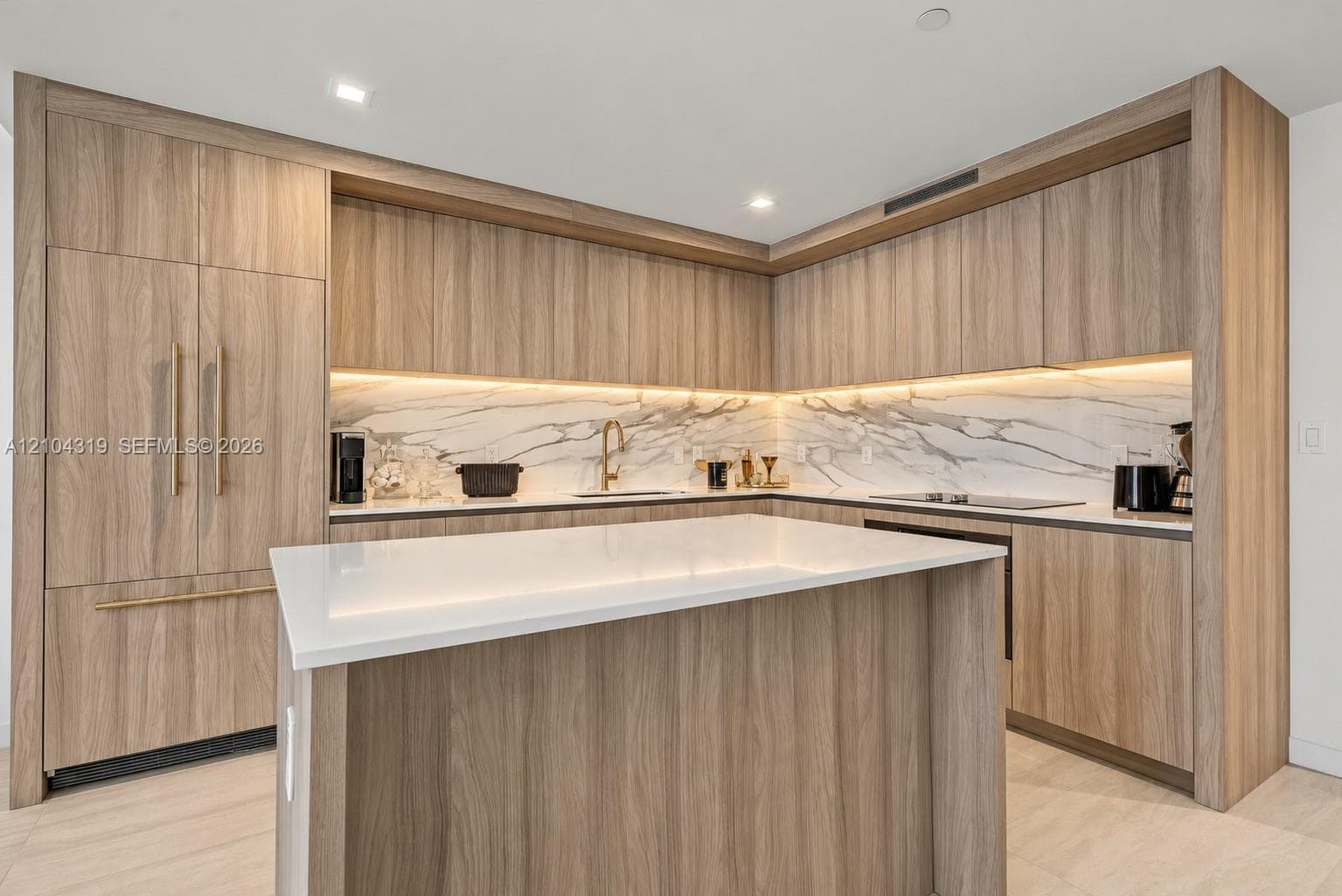 Kitchen featuring wood-finish cabinetry with integrated appliances, stone-patterned backsplash, quartz-topped center island, and recessed ceiling lighting
