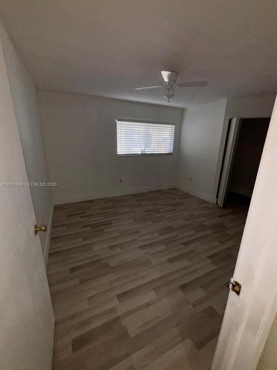 Wood-finish flooring, ceiling fan, and horizontal window blinds