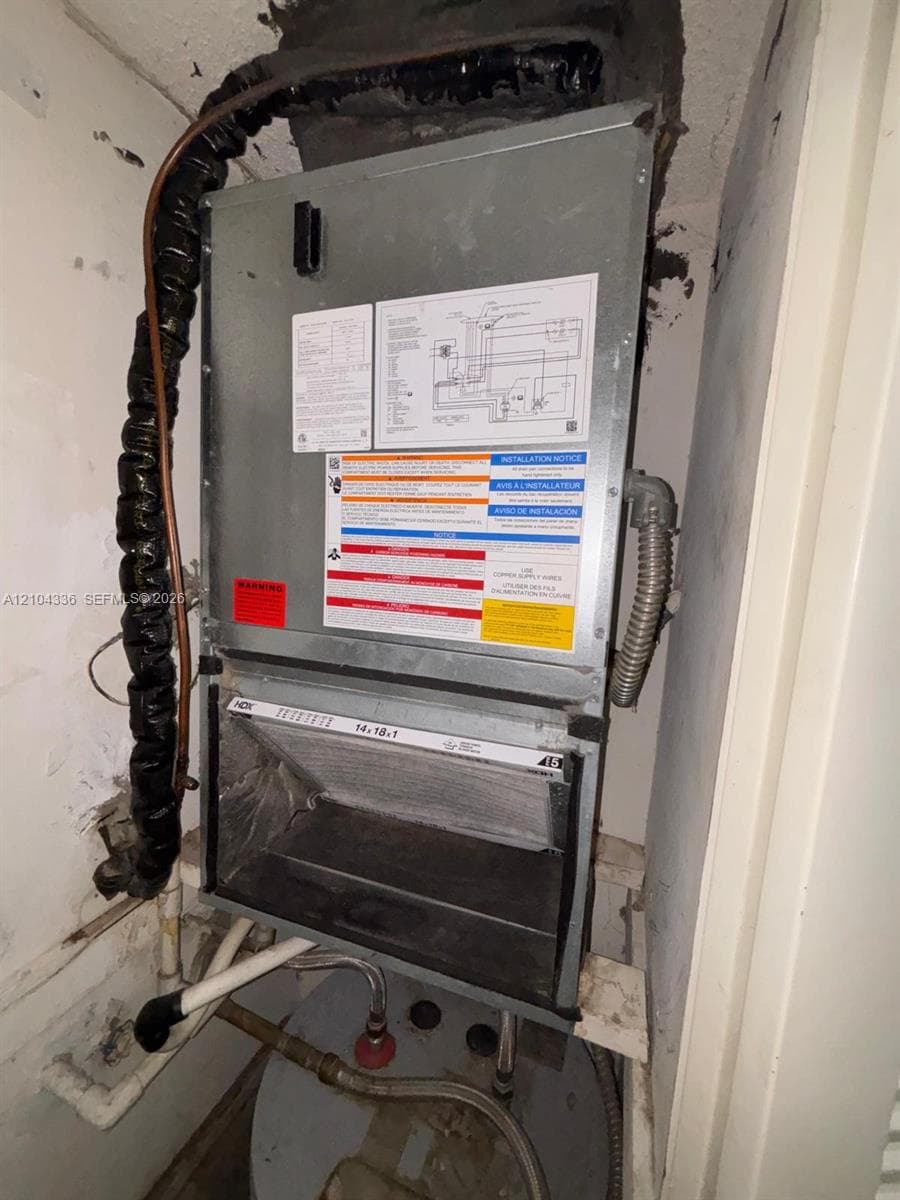 Climate control unit featuring an accessible filter compartment, metal housing, and integrated piping