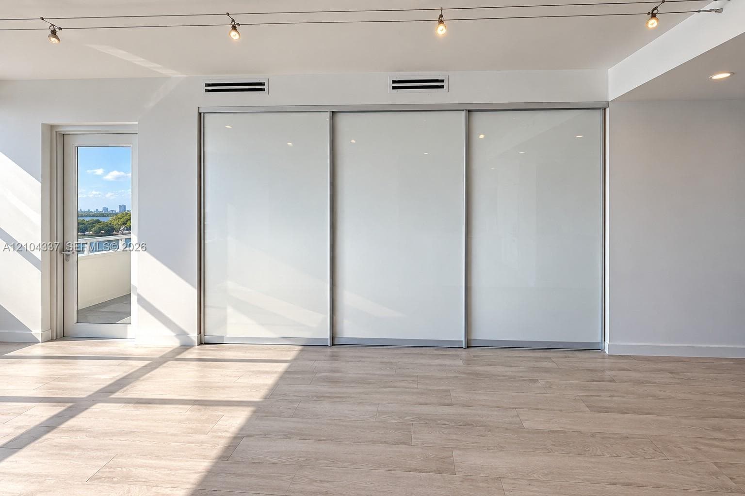 Versatile Den / Guest Suite — Virtually staged to illustrate two possible uses of the space: a private home office or guest bedroom. Floor-to-ceiling sliding glass panels allow for an open or enclosed layout.