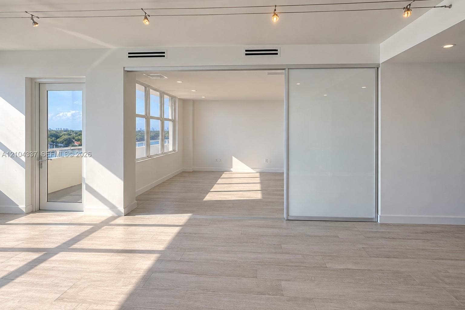 Versatile Den / Guest Suite — Virtually staged to illustrate two possible uses of the space: a private home office or guest bedroom. Floor-to-ceiling sliding glass panels allow for an open or enclosed layout.