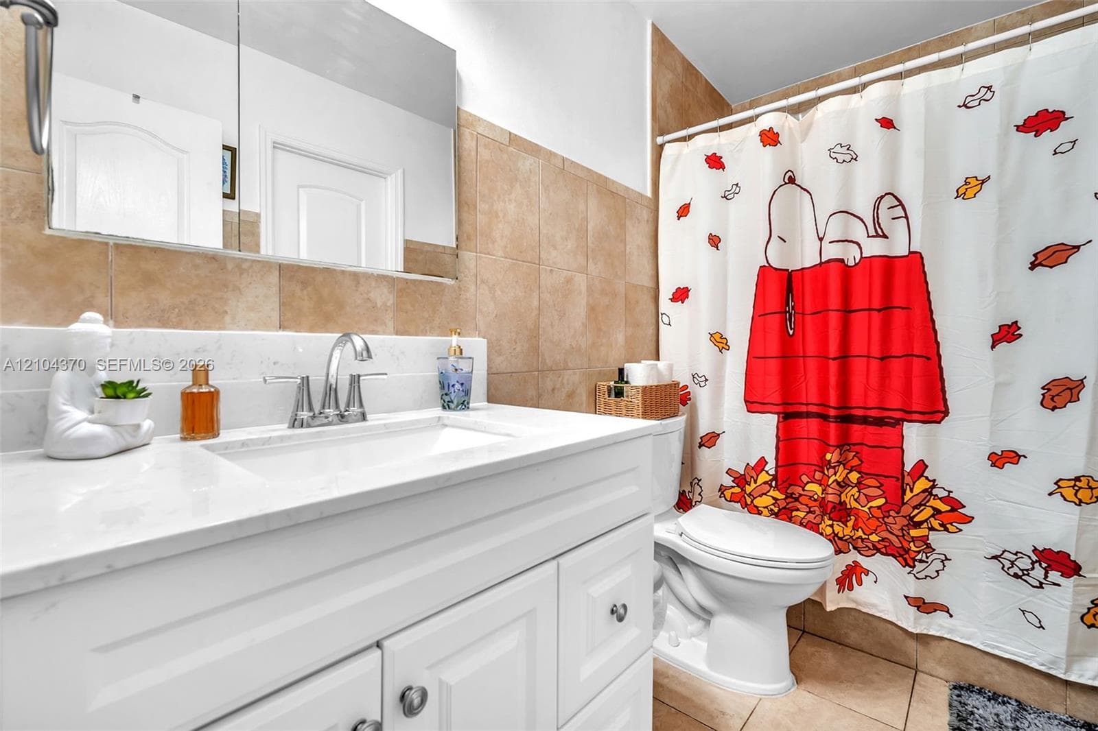 Room featuring ceramic tile flooring, crown molding, and a central ceiling fan with an integrated light fixture