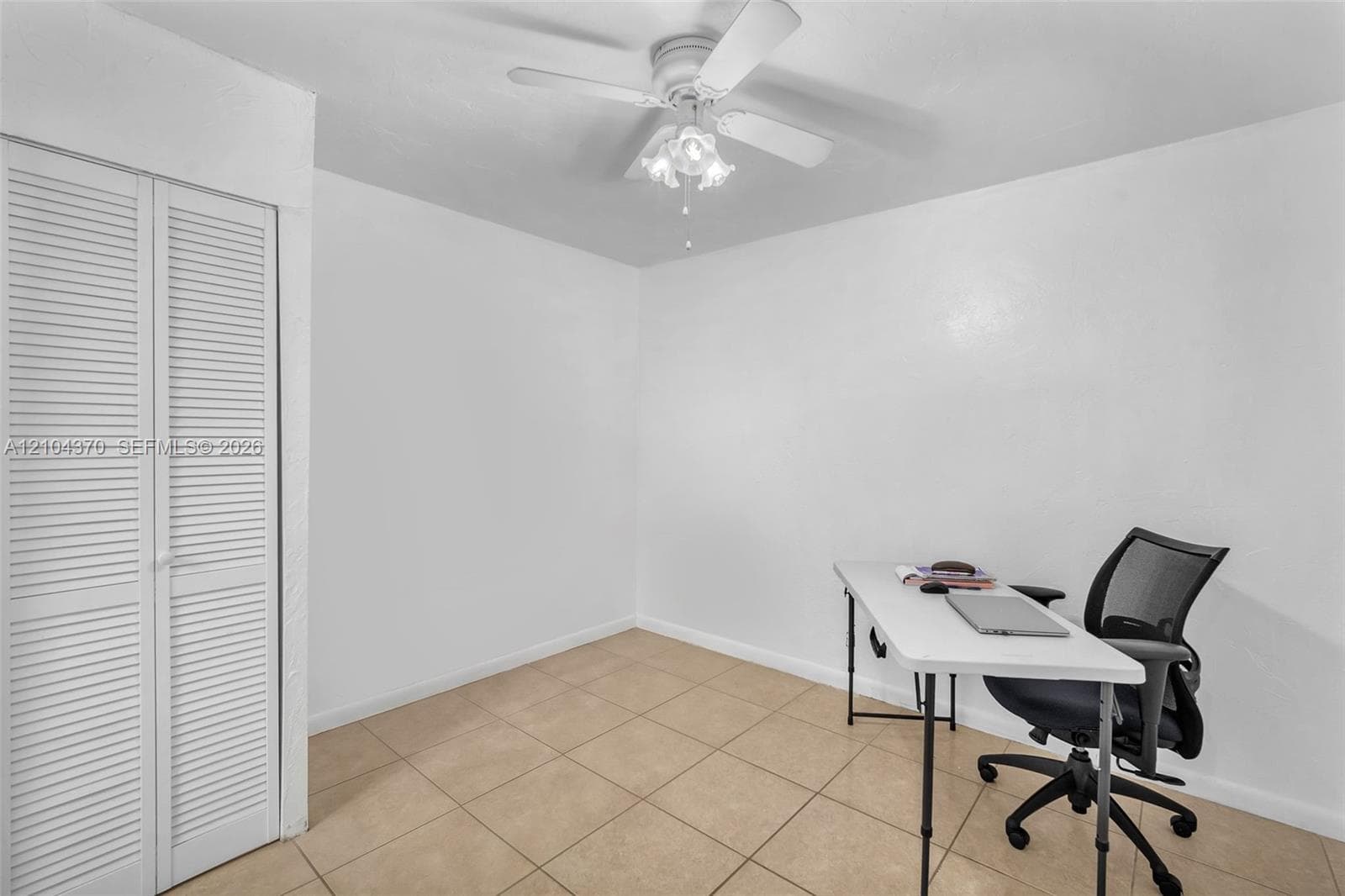 Ceramic tile flooring, crown molding, and a matte black ceiling fan