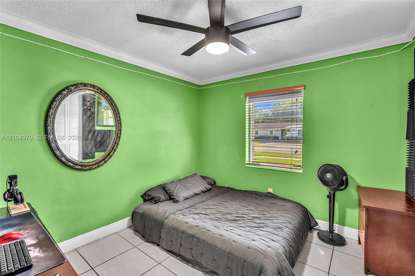 Neutral tile flooring, ceiling fan with integrated lighting, and louvered closet doors