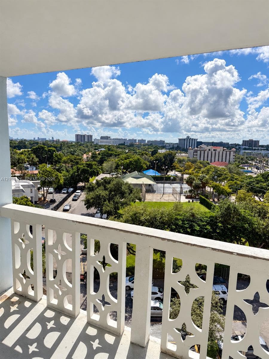 Elevated balcony featuring decorative white geometric railings and an expansive outdoor exposure