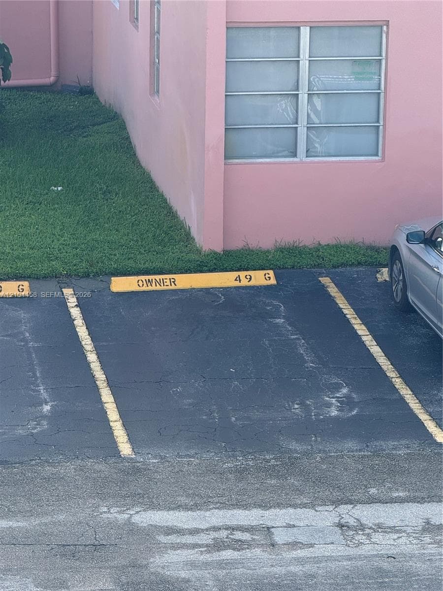 Designated parking space 49G with asphalt surface and painted stall markers