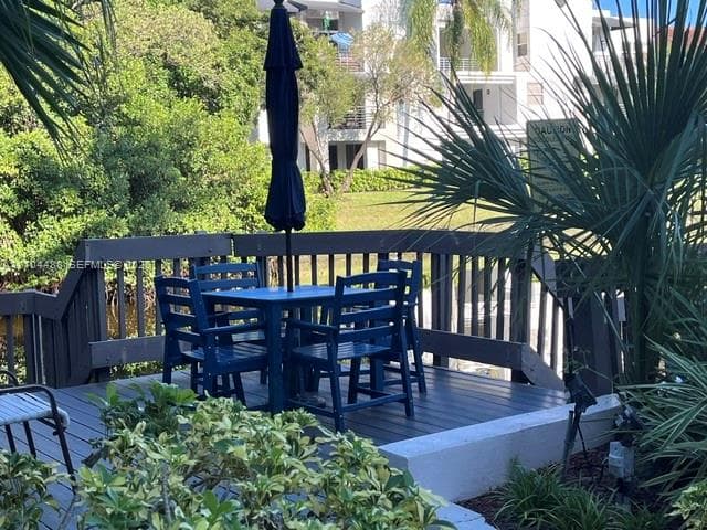 Elevated composite deck featuring dark-toned decking boards and a matching perimeter railing