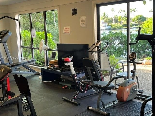 Fitness center featuring expansive floor-to-ceiling windows and rubberized gym flooring