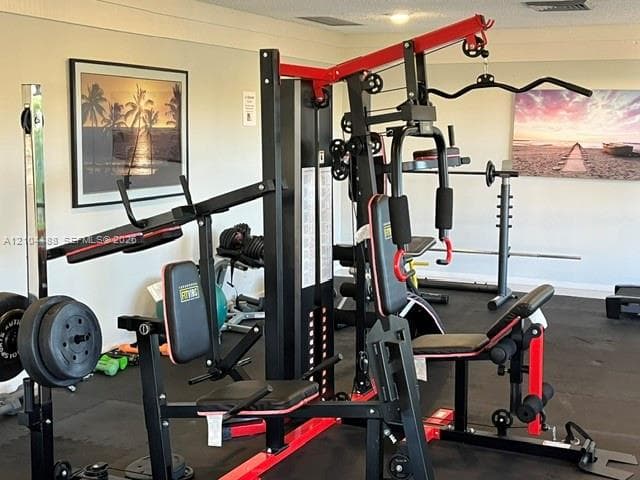 Fitness space featuring impact-resistant rubberized flooring and neutral wall finish