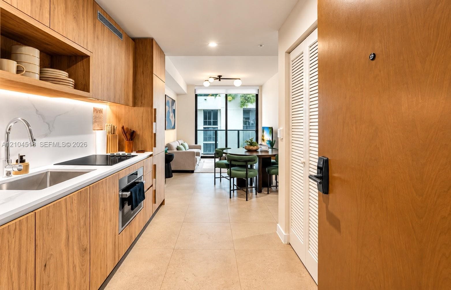 Wood-finish cabinetry with integrated appliances and under-cabinet lighting
