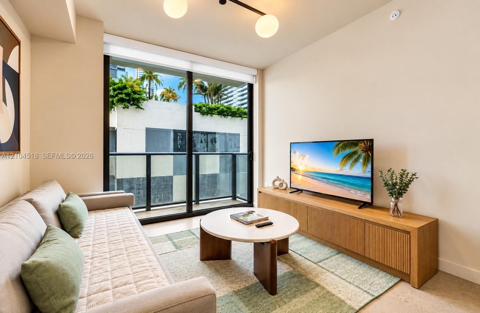 Expansive sliding glass doors, contemporary track lighting, full-height windows, a built-in wood-finish media console, and a balcony with glass railings