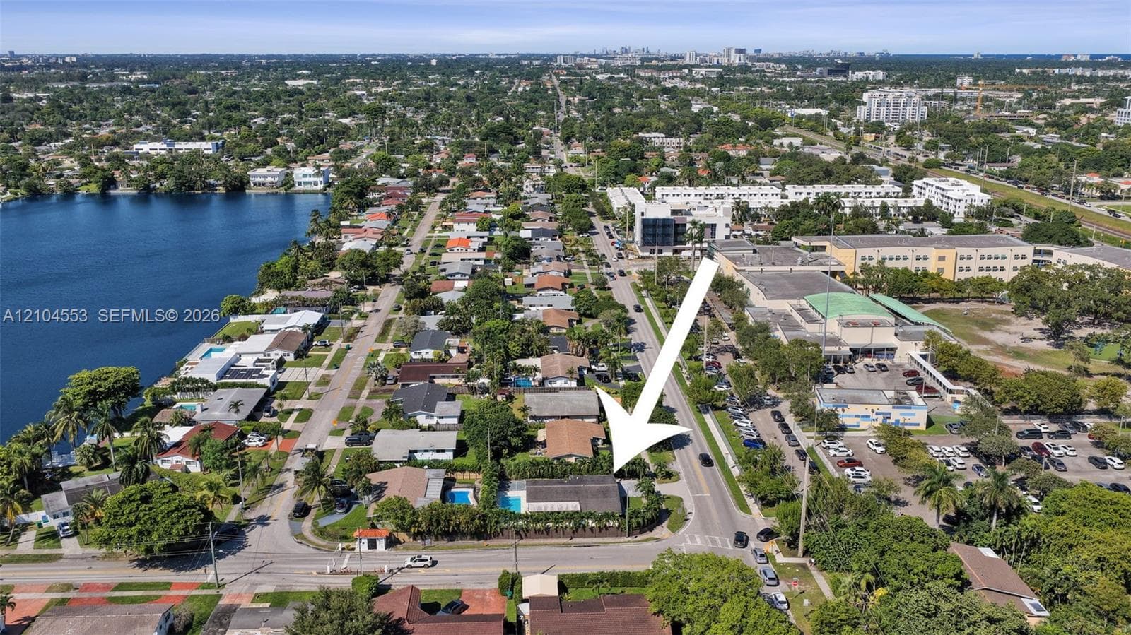 Aerial perspective highlighting corner lot positioning with a backyard pool and established perimeter landscaping