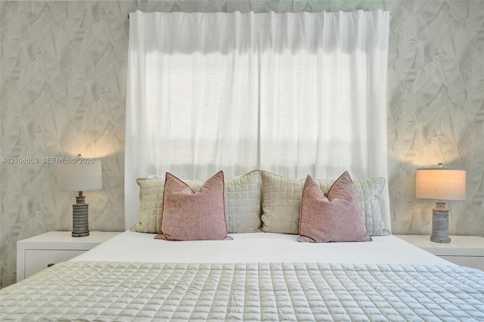 Neutral-toned leaf-patterned wallpaper and horizontal window with white-fabric window treatments
