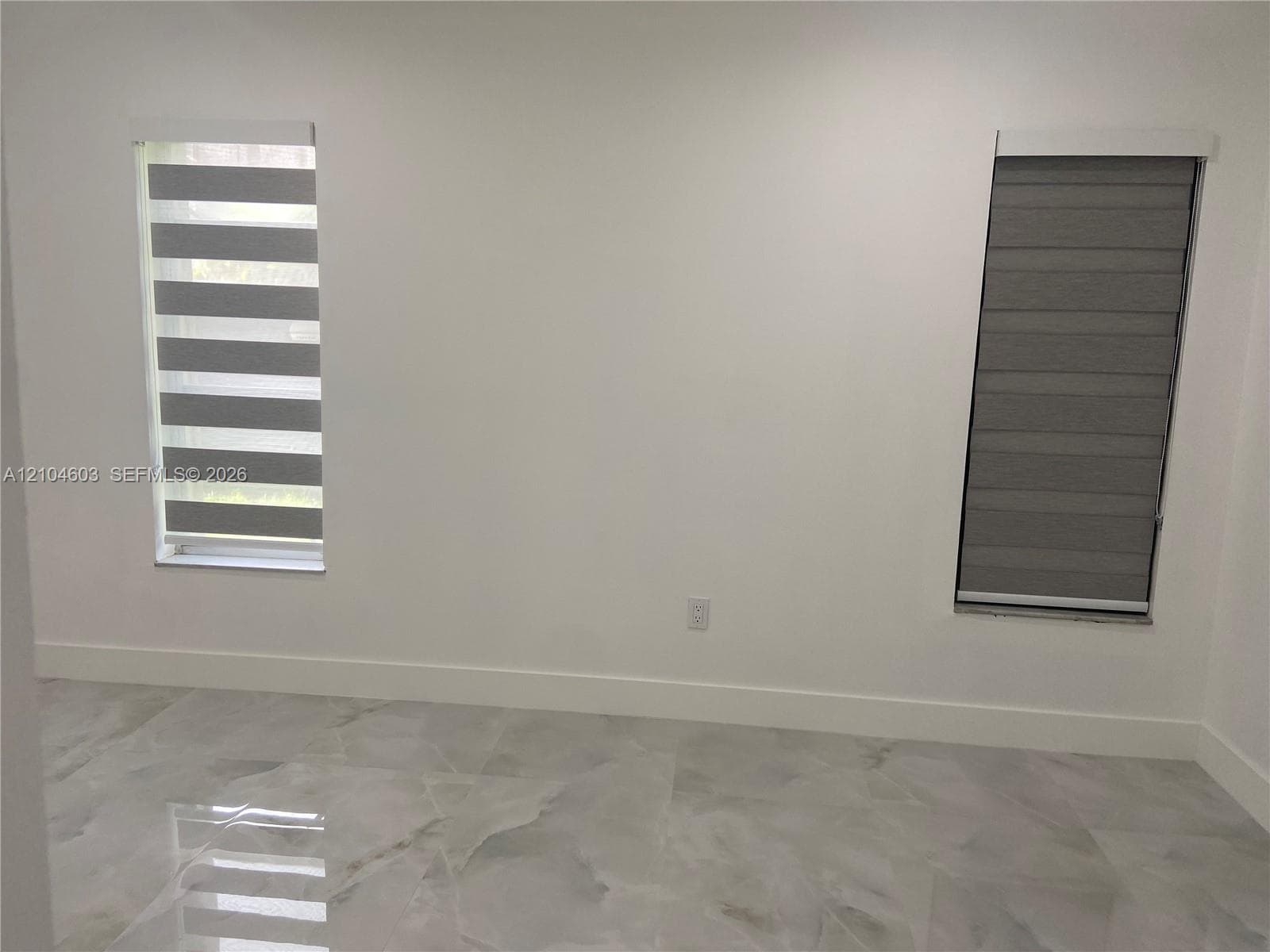 Light grey stone-finish flooring with white walls and trim