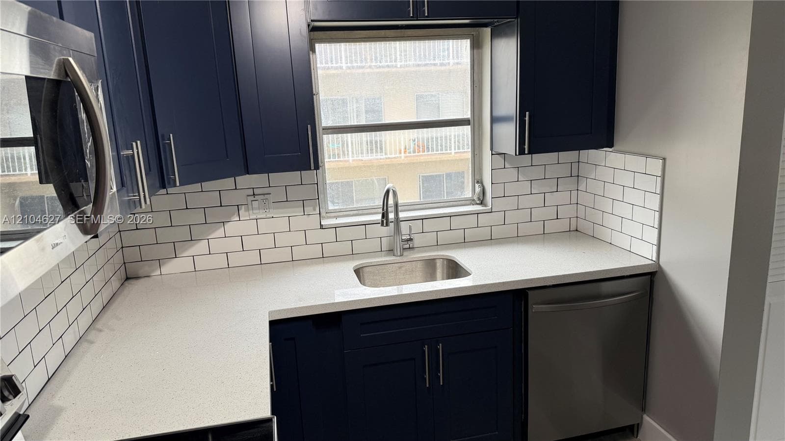 Quartz countertops with under mount stainless sink.