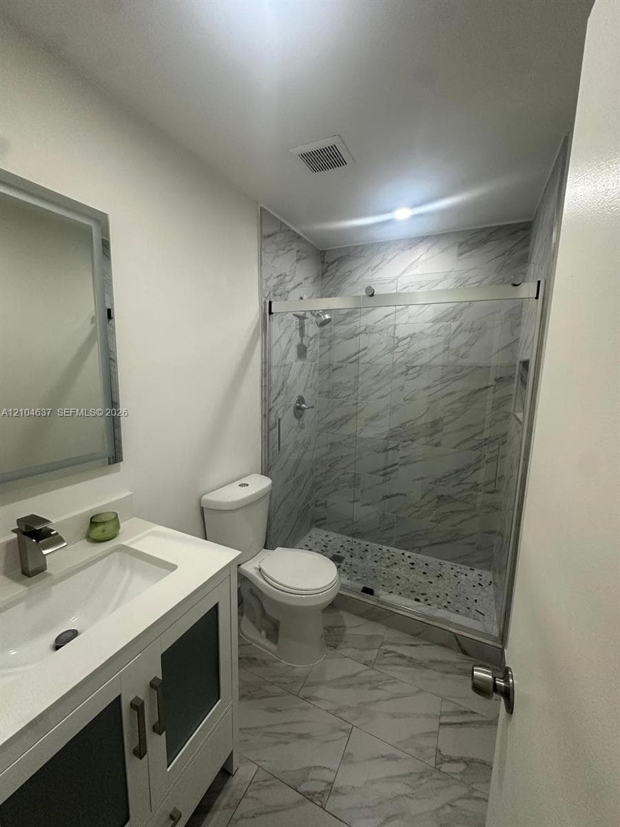 White vanity with integrated sink and chrome faucet