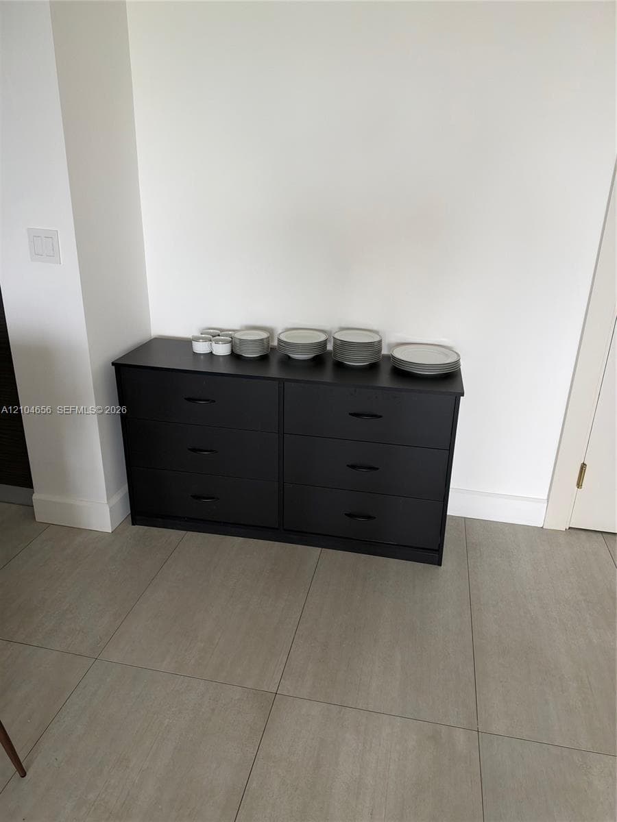 Large-format neutral floor tiling featuring a smooth matte finish