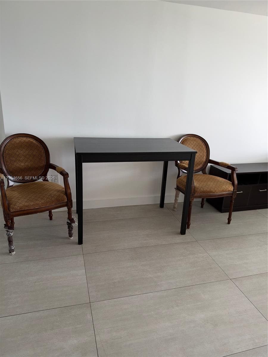 Neutral-toned large-format floor tiling throughout