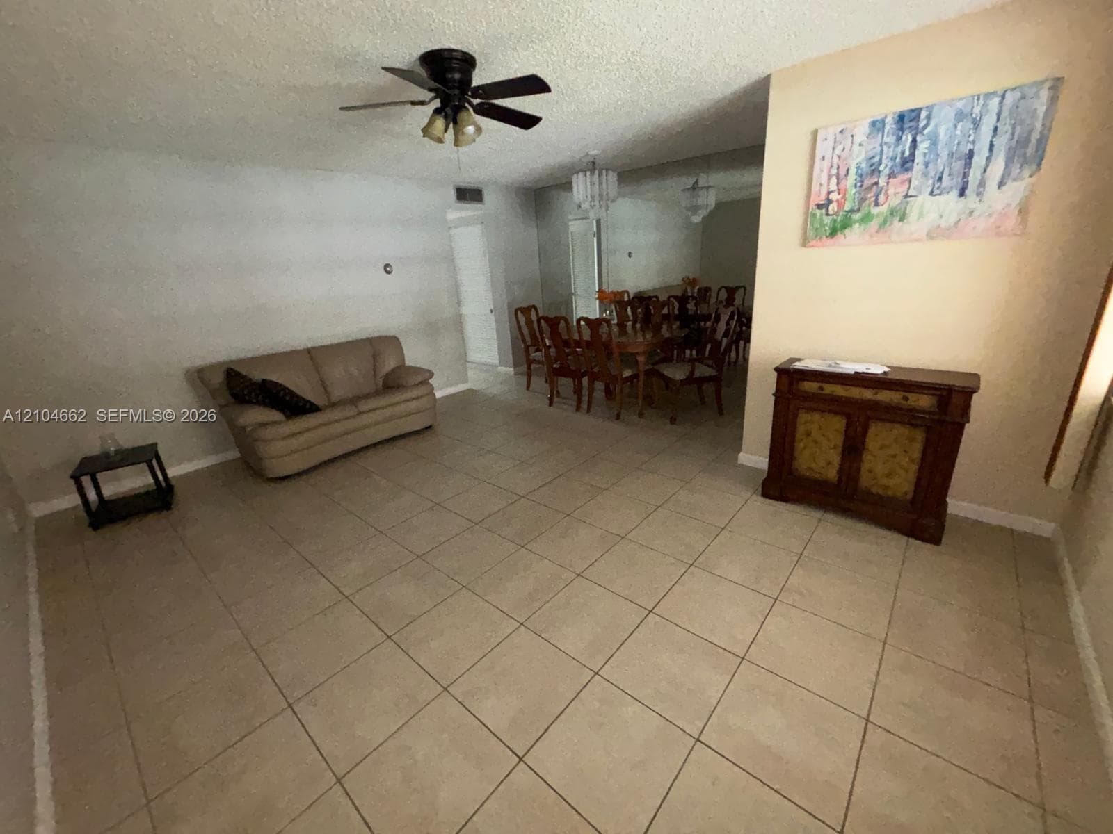 Tiled flooring throughout, ceiling fan with integrated lighting, and a separate dining area