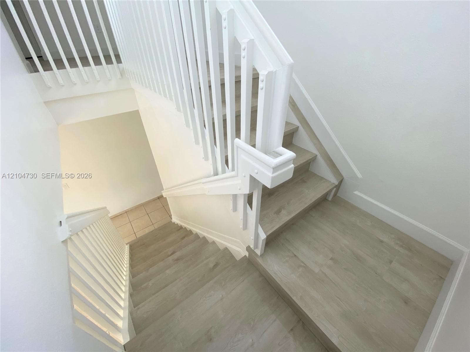 Stairs with recently installed laminated flooring.