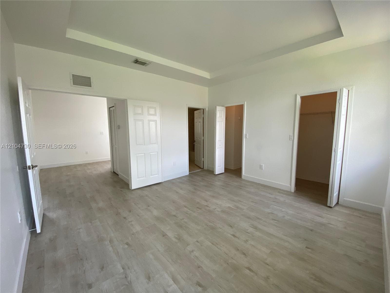 Master bedroom with large walk-in closets and bathroom.