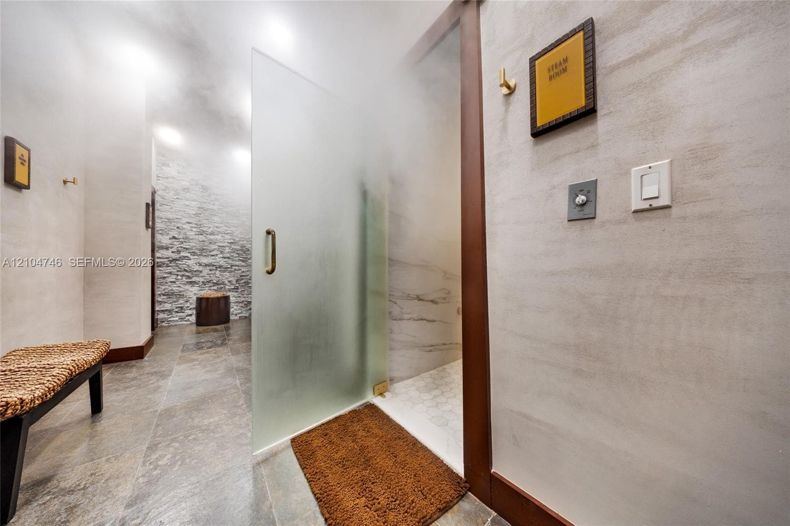 Interior space featuring full-wall mirrors, recessed lighting, multi-pane windows, and durable rubber flooring