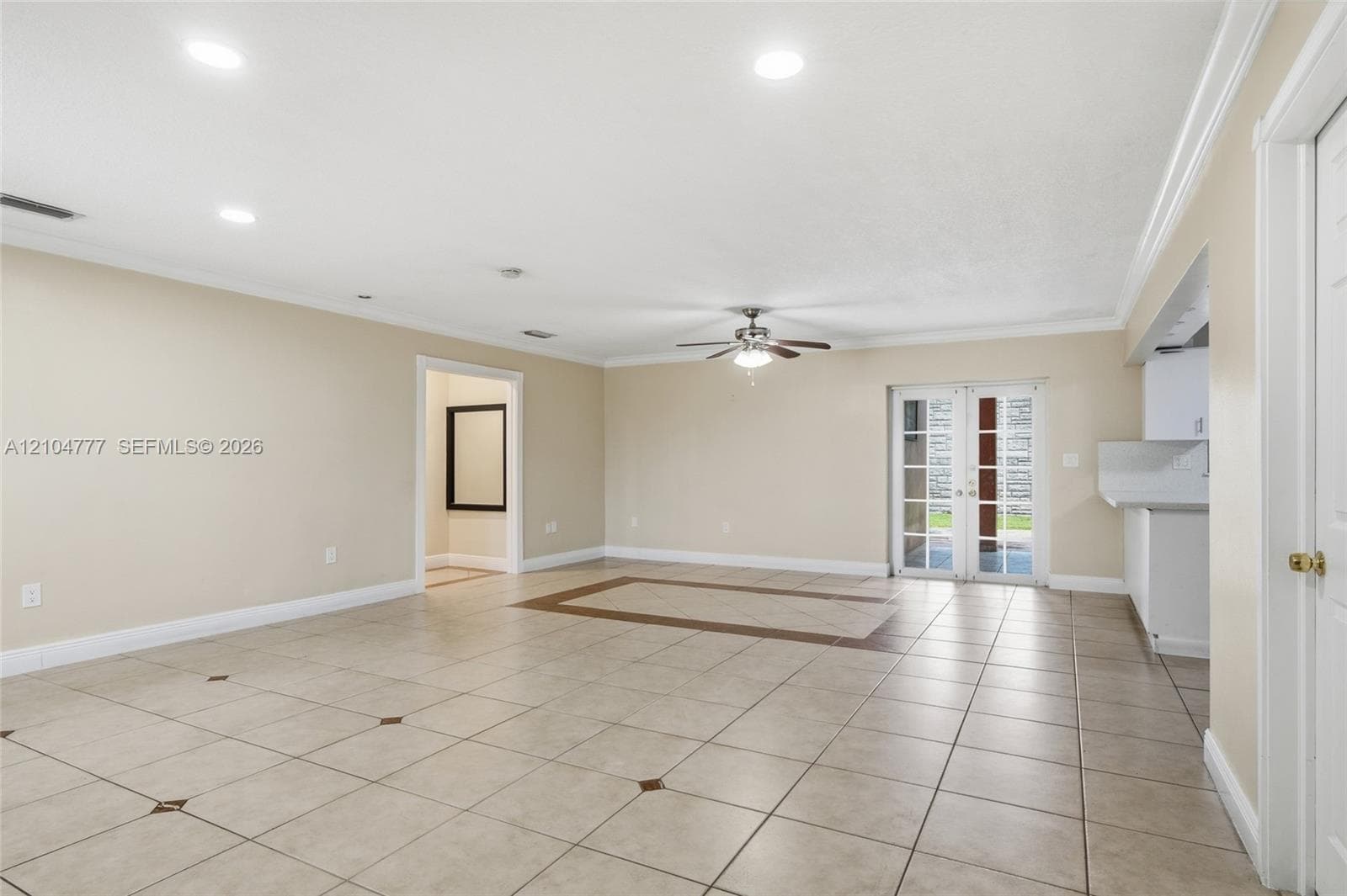 Spacious interior with tile flooring, ceiling fan, recessed lighting, and crown molding