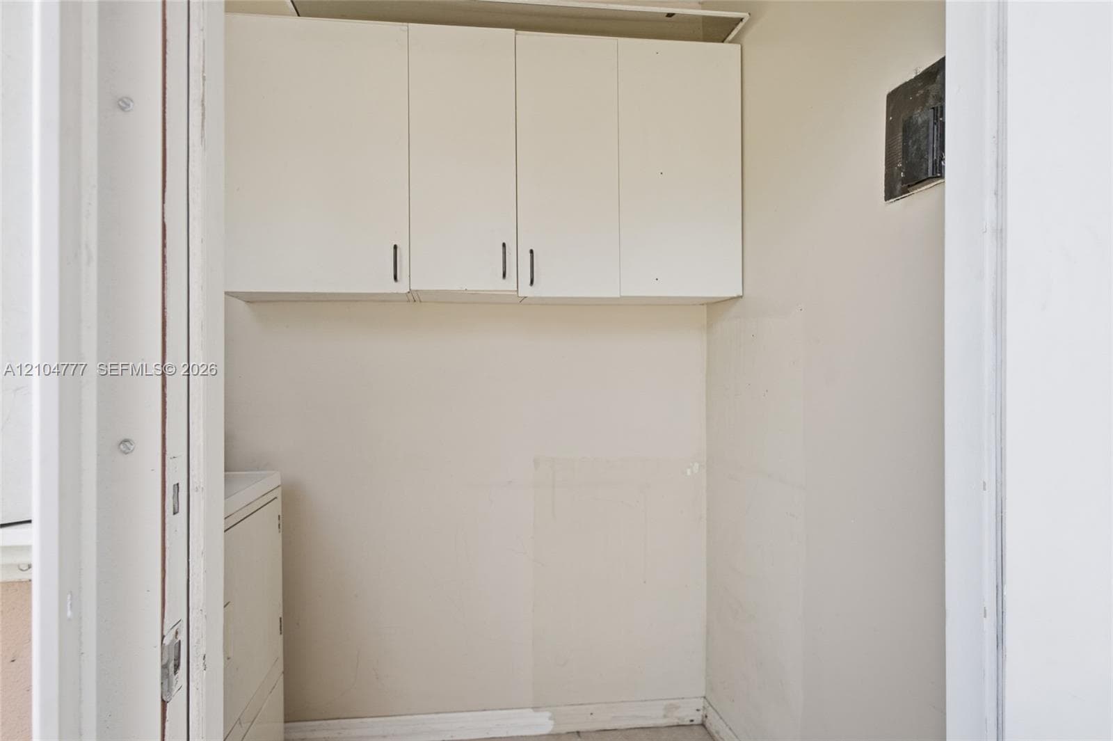 Built-in upper cabinetry with white flat-panel doors and dark hardware