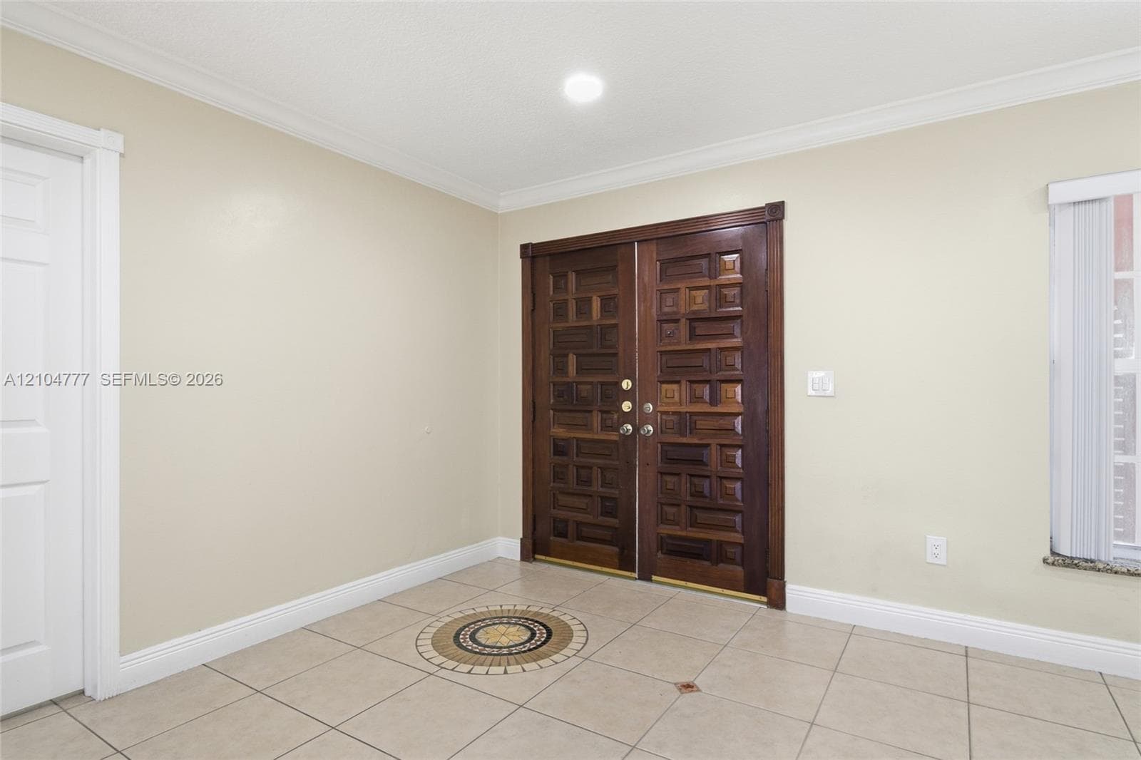 Double entry doors with intricate wood paneling
