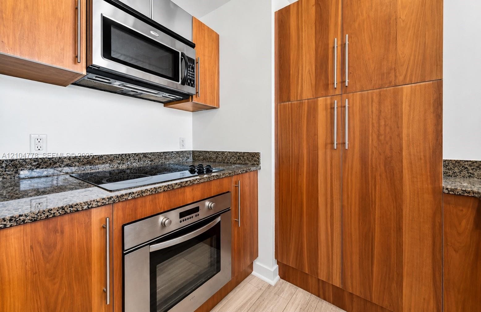 Wood-finish cabinetry complemented by stainless steel appliances