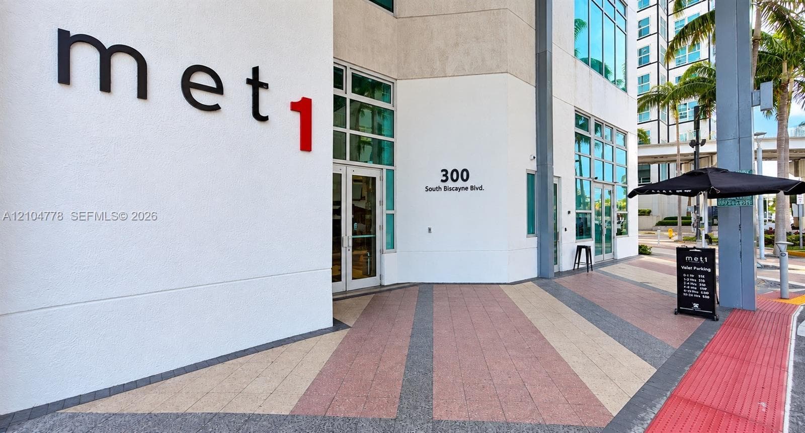 Modern building exterior with large glass windows and storefront entry