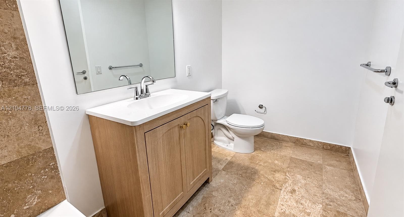 Light wood-finish vanity with a white countertop and integrated sink