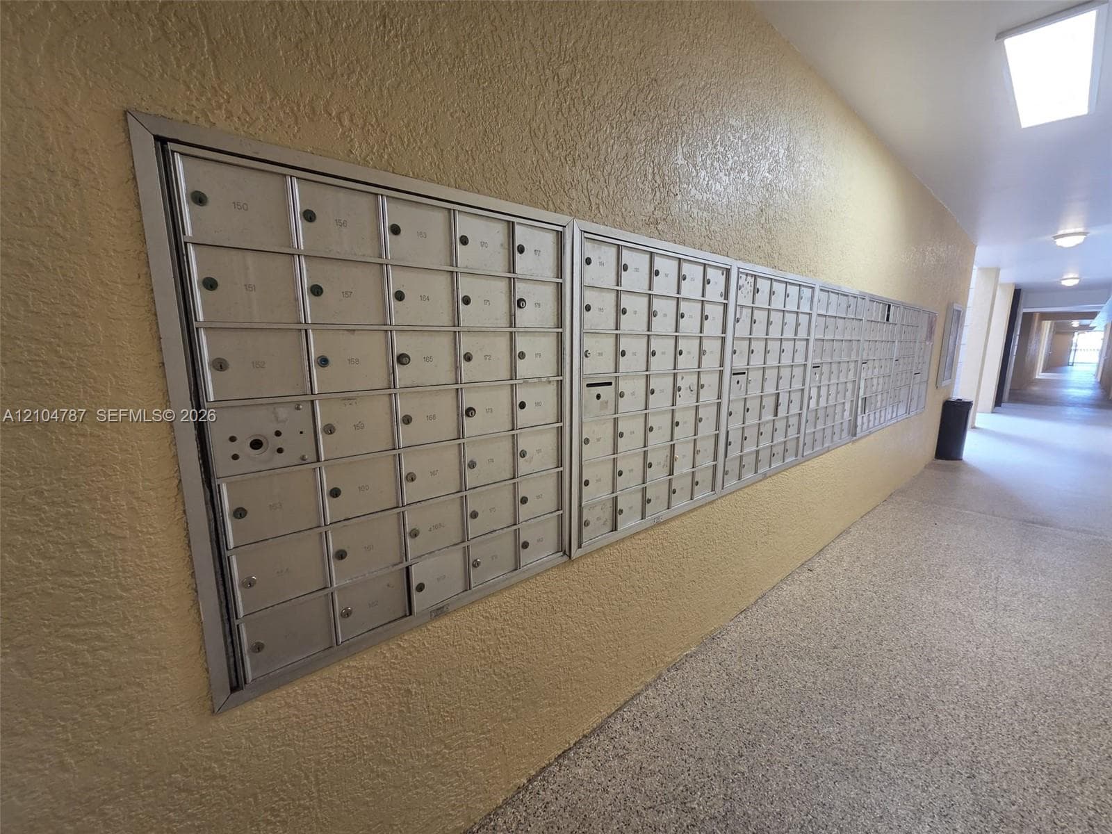 Wall-mounted bank of stainless steel mailboxes featuring individual locking compartments