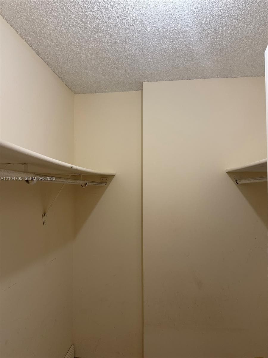 Built-in storage closet featuring dual-level shelving and integrated hanging rods