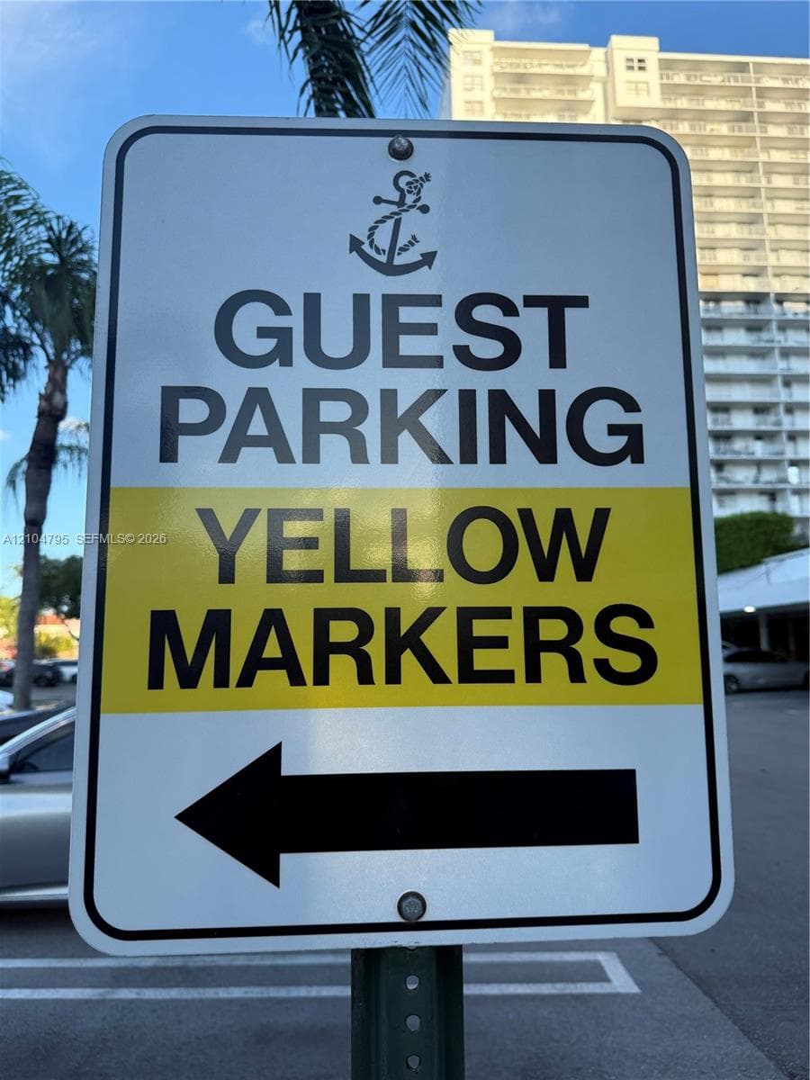 Designated guest parking area with marked spaces and directional signage