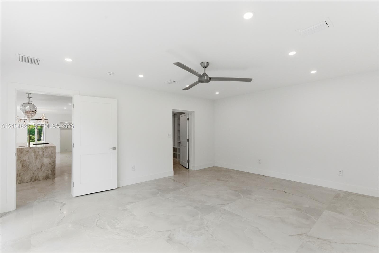 Neutral-toned tile flooring, recessed ceiling lighting, and a modern ceiling fan