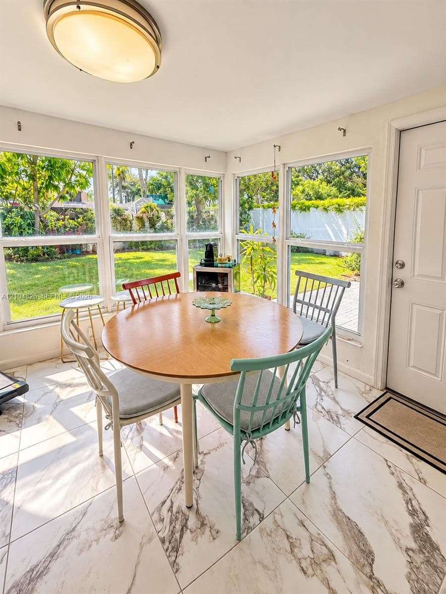 Room featuring large windows, white walls, and a ceiling-mounted light fixture