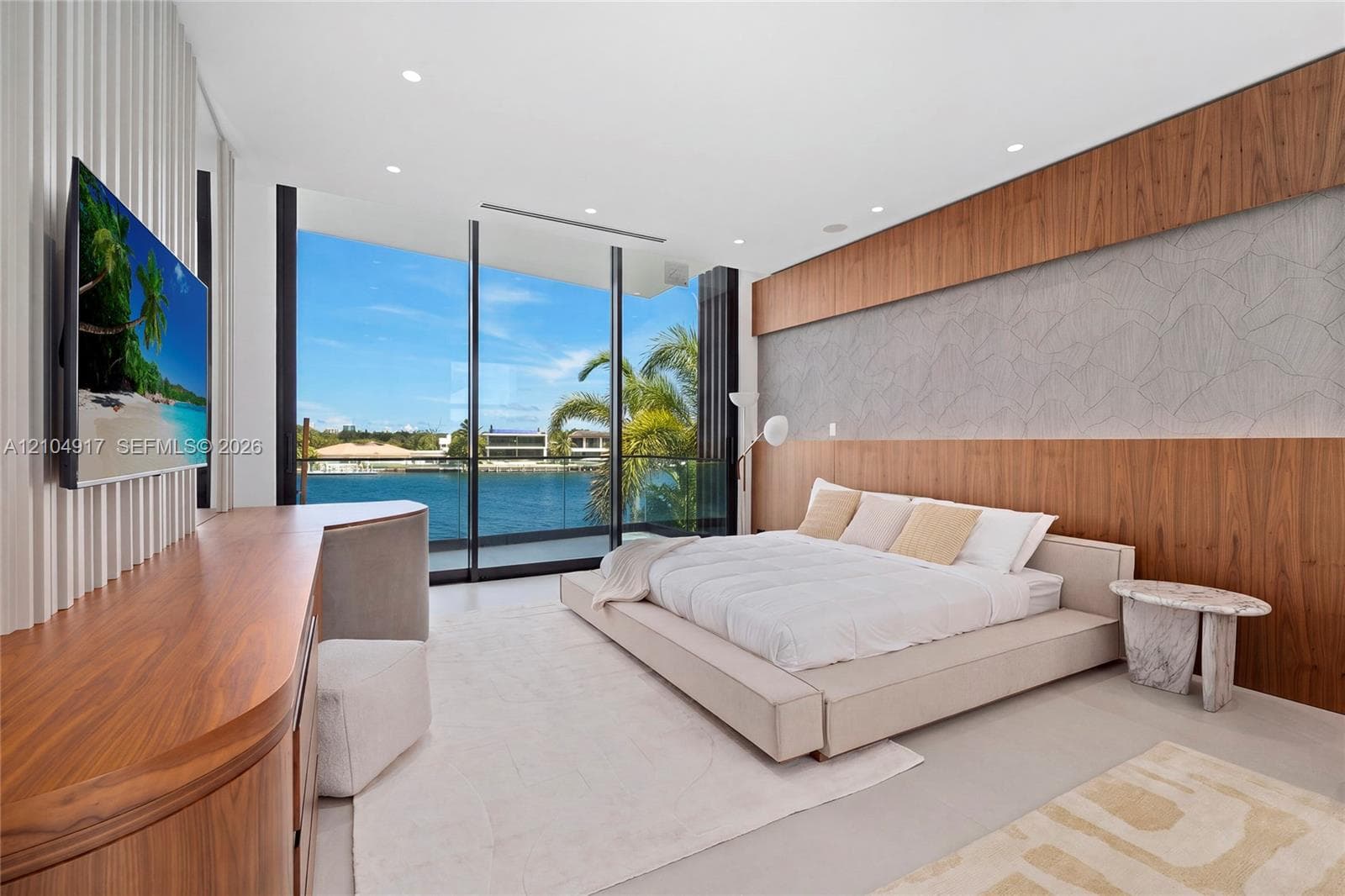 Floor-to-ceiling glass doors, wood-finish accent wall, textured wall paneling, recessed lighting, and light-toned flooring