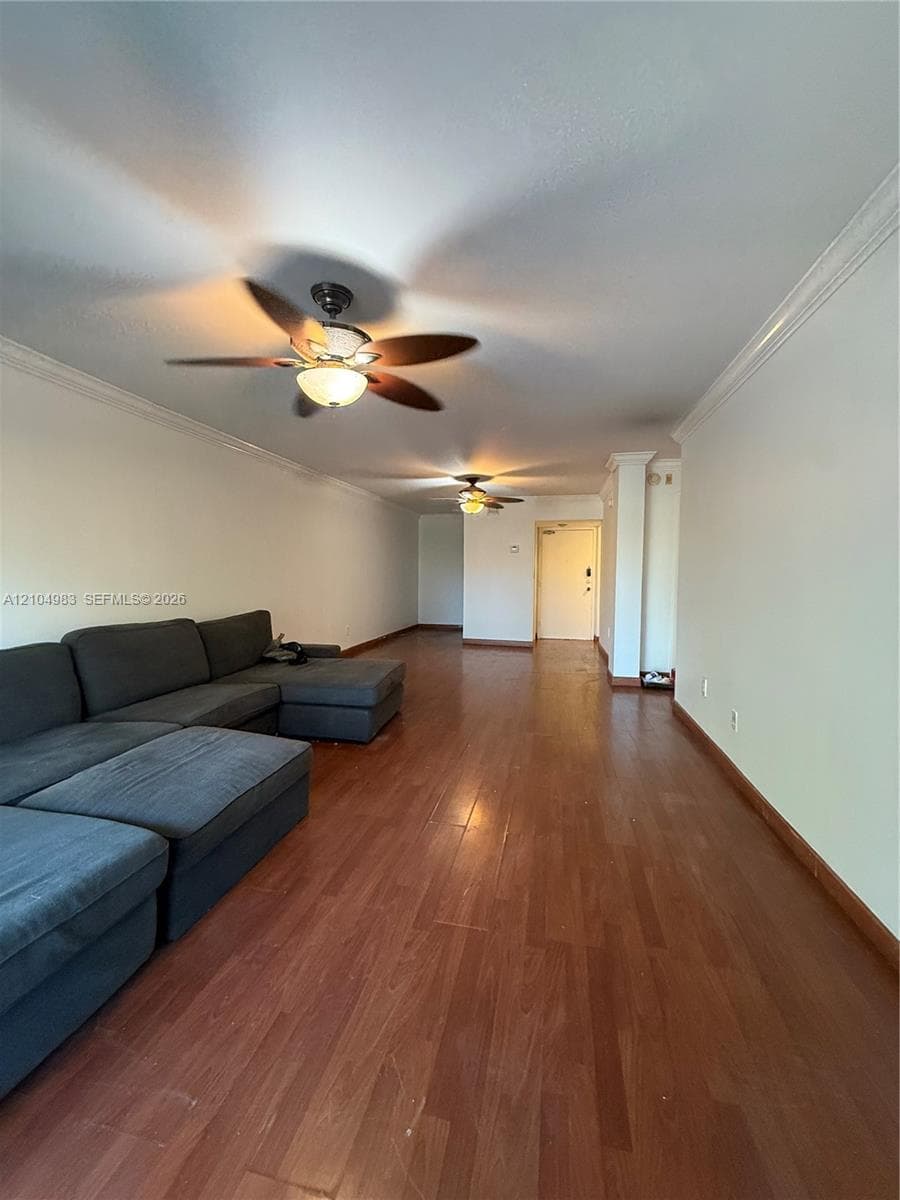 Wood-finish flooring, crown molding, and dual ceiling fans