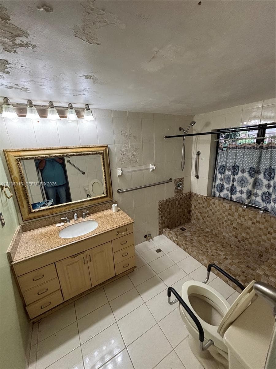 Vanity with a single basin sink, granite countertop, and wood-finish cabinetry